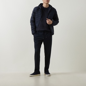 Model wearing Boss Green Label Dark Blue jacket with matching navy hoodie, joggers, and grey trainers.