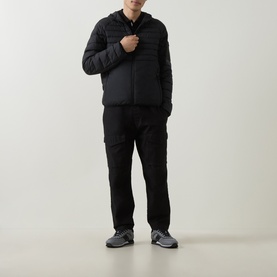 Model wearing Boss Green Label black quilted jacket with zip fastening, styled with black cargo trousers and grey trainers