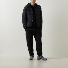 Model wearing Boss Green Label black quilted puffer jacket with hood, styled with black joggers and grey trainers, carrying a crossbody bag.