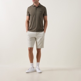 Model wearing Boss Green Label Commuter 10.5" Golf Shorts in light beige, slim fit, styled with an olive polo shirt and white trainers.