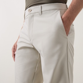 Model wearing Boss Green Label Commuter 10.5" Golf Shorts in light beige, slim fit, showing zip fly, belt loops and side pocket detail