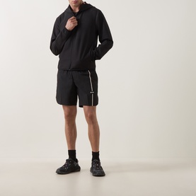 Model wearing Boss Green Label TOC Game 8" Golf Shorts in black with white stripe detail, styled with matching black hoodie and trainers.