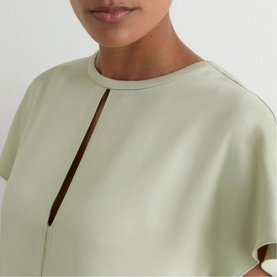 Model wearing Reiss grey dress with keyhole neckline detail and short flutter sleeves, close-up view