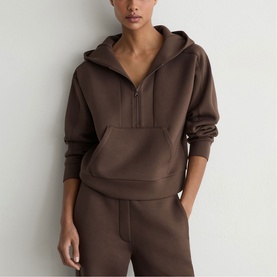 Model wearing Reiss mocha brown zip-neck hoodie with kangaroo pocket, styled with matching mocha brown joggers
