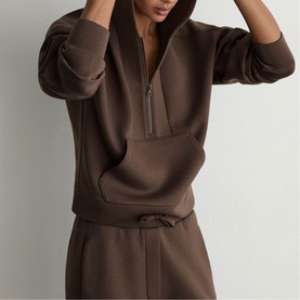 Model wearing Reiss mocha brown zip-neck hoodie, styled with matching drawstring wide-leg trousers
