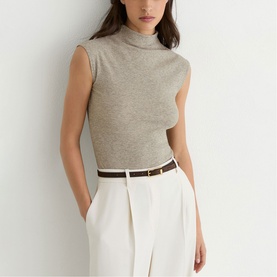 Model wearing Reiss gold sleeveless mock-neck knit top, styled with white wide-leg trousers and a brown leather belt.
