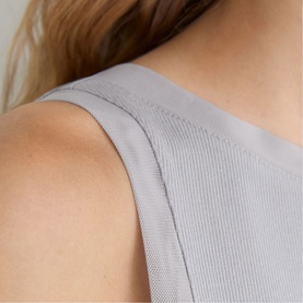 Model wearing Reiss grey top, close-up of shoulder seam detail showing smooth fabric construction.
