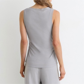 Model wearing Reiss grey sleeveless ribbed vest top, styled with matching grey wide-leg trousers, back view