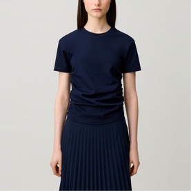 Model wearing Claude Pierlot blue short-sleeve crew-neck T-shirt, styled with a navy pleated midi skirt.