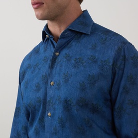Model wearing Eton Floral Denim Shirt in denim blue with tonal floral print, cut-away collar, and gold-tone buttons visible at close range.