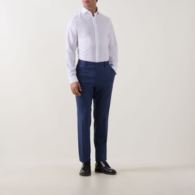 Model wearing Eton Signature Oxford Shirt in white with wide spread collar, styled with navy tailored trousers and black dress shoes.