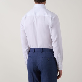 Model wearing Eton Signature Oxford Shirt in white, back view, styled with blue tailored trousers.