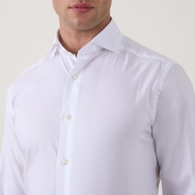Model wearing Eton Signature Oxford Shirt in white, showing wide spread collar and front button fastening detail.