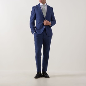 Model wearing Eton Signature Oxford Shirt in white with wide spread collar, styled with a blue suit and black dress shoes.