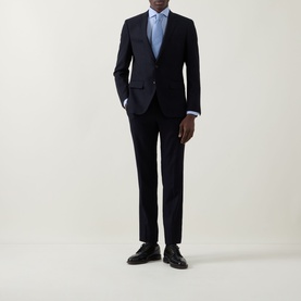 Model wearing Eton Signature Oxford Shirt in light blue with wide spread collar, styled with navy suit and black dress shoes.