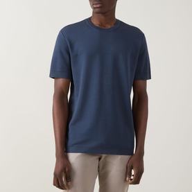 Model wearing Eton Dark Blue cotton crew neck T-shirt, styled with stone chinos