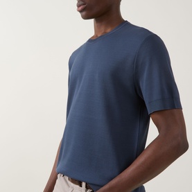 Model wearing Eton Dark Blue cotton crew neck T-shirt, styled with light beige trousers