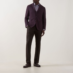 Model wearing Eton Lana Tech Single-Breasted Blazer in dark red with striped shirt and dark trousers