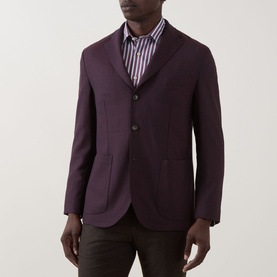 Model wearing Eton Lana Tech Single-Breasted Blazer in dark red, notched lapels, three-button fastening, styled with striped shirt and dark trousers