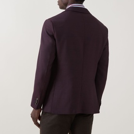 Model wearing Eton Lana Tech Single-Breasted Blazer in dark red, showing rear view with double vent, buttoned cuffs, styled with dark trousers