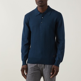 Model wearing Eton Chevron Structure Polo Shirt in mid blue, long-sleeved knit with chevron texture and flat collar, styled with grey trousers