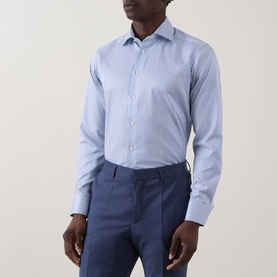 Model wearing Eton Bengal Stripe Single-Cuff Shirt in teal, cut-away collar, long sleeves, styled with navy trousers.