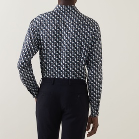 Model wearing Eton Geometric Print Single-Cuff Shirt in navy blue with all-over geometric pattern, long sleeves, styled with navy trousers. Rear view.