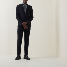 Model wearing Eton Geometric Print Single-Cuff Shirt in navy blue with cut-away collar, styled with dark suit and black leather shoes.