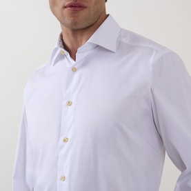 Model wearing Eton Solid Single-Cuff Shirt in white, featuring cut-away collar, gold buttons, and geometric pattern detail at inner collar.