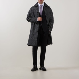 Model wearing Eton Solid Single-Cuff Shirt in white, styled with dark grey overcoat, black trousers, lilac tie and black dress shoes.