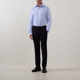 Model wearing Eton Solid Single-Cuff Shirt in light blue with cut-away collar and long sleeves, styled with navy trousers and black shoes.