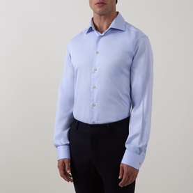 Model wearing Eton Solid Single-Cuff Shirt in light blue cotton with cut-away collar and single cuffs, styled with dark trousers