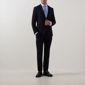 Model wearing Eton Solid Single-Cuff Shirt in light blue with cut-away collar, styled with navy suit and black leather shoes.