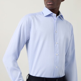Model wearing Eton Light Blue Single Cuff Slim formal shirt in 100% cotton, styled with dark trousers. Spread collar detail visible.