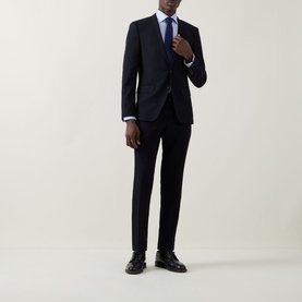 Model wearing Eton Light Blue Single Cuff Slim shirt, styled with navy suit and tie, paired with black leather shoes.
