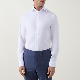 Model wearing Eton Twill Single Cuff Shirt in white with pointed collar and single cuffs, styled with navy blue trousers.