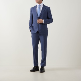 Model wearing Eton Twill Single Cuff Shirt in white, styled with a blue suit, light blue tie, and black dress shoes.