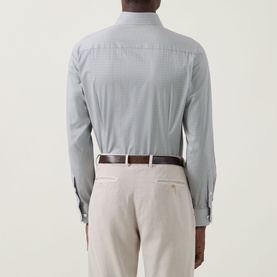 Model wearing Eton Micro Print Single-Cuff Shirt in navy blue, back view, styled with beige trousers and brown leather belt