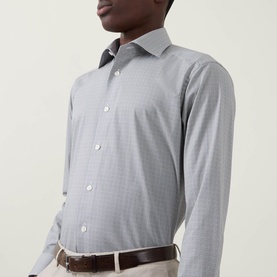 Model wearing Eton Micro Print Single-Cuff Shirt in navy blue, spread collar, slim fit, styled with light trousers and brown belt