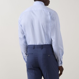Model wearing Eton Prince of Wales Check Shirt in light blue, single cuff, long sleeves. Styled with navy trousers, rear view shown.