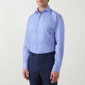 Model wearing Eton Mid Blue cotton formal shirt with single cuff and spread collar, styled with navy trousers.
