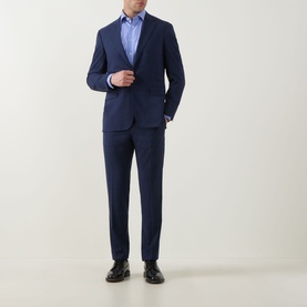 Model wearing Eton Mid Blue Single Cuff Regular shirt, styled with a navy suit and black leather shoes.