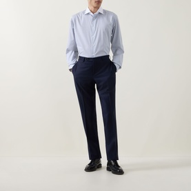 Model wearing Eton Light Blue Single Cuff Regular shirt in cotton, styled with navy tailored trousers and black loafers.