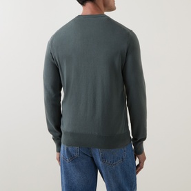 Model wearing Hugo Boss Orange Open Green cotton-cashmere crew neck jumper, styled with blue jeans. Rear view.