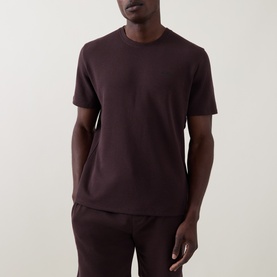 Model wearing Hugo Boss Dark Brown cotton-blend pyjama top with crew neck and short sleeves, styled with matching dark brown bottoms.