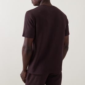 Model wearing Hugo Boss Dark Brown pyjama top, short-sleeved crew neck, shown from the back with matching trousers