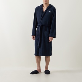 Model wearing Hugo Boss Logo Fleece Belted Robe in dark blue with self-tie belt and hood, styled with navy slippers