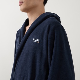 Model wearing Hugo Boss Logo Fleece Belted Robe in dark blue, showing embroidered chest logo and hood detail.