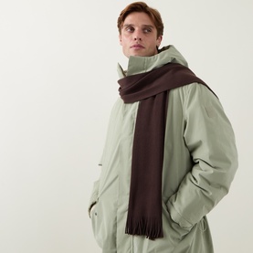 Model with Hugo Boss Albas Logo Fringed Scarf in dark brown, knitted wool with fringe trim, styled with sage green jacket