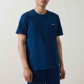 Model wearing blue crew neck t-shirt with small chest logo print, paired with matching blue shorts